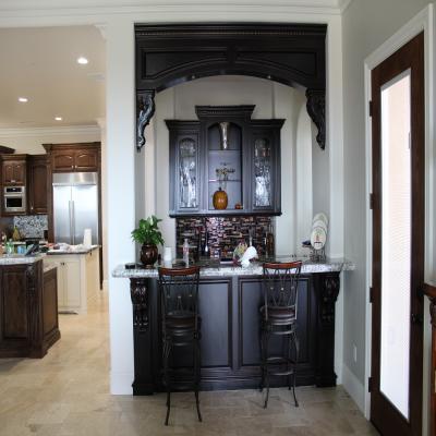 Custom bar in a dark stain with glass doors. 
