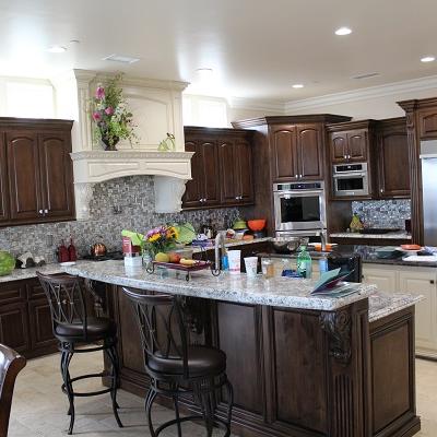 Complete Kitchen cabinets in a dark stain and painted island. 